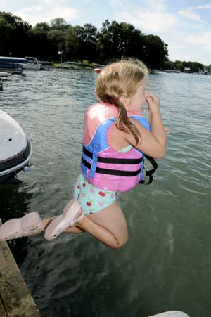 girl jumping off dock