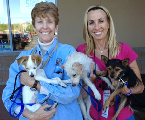 two women holding dogs